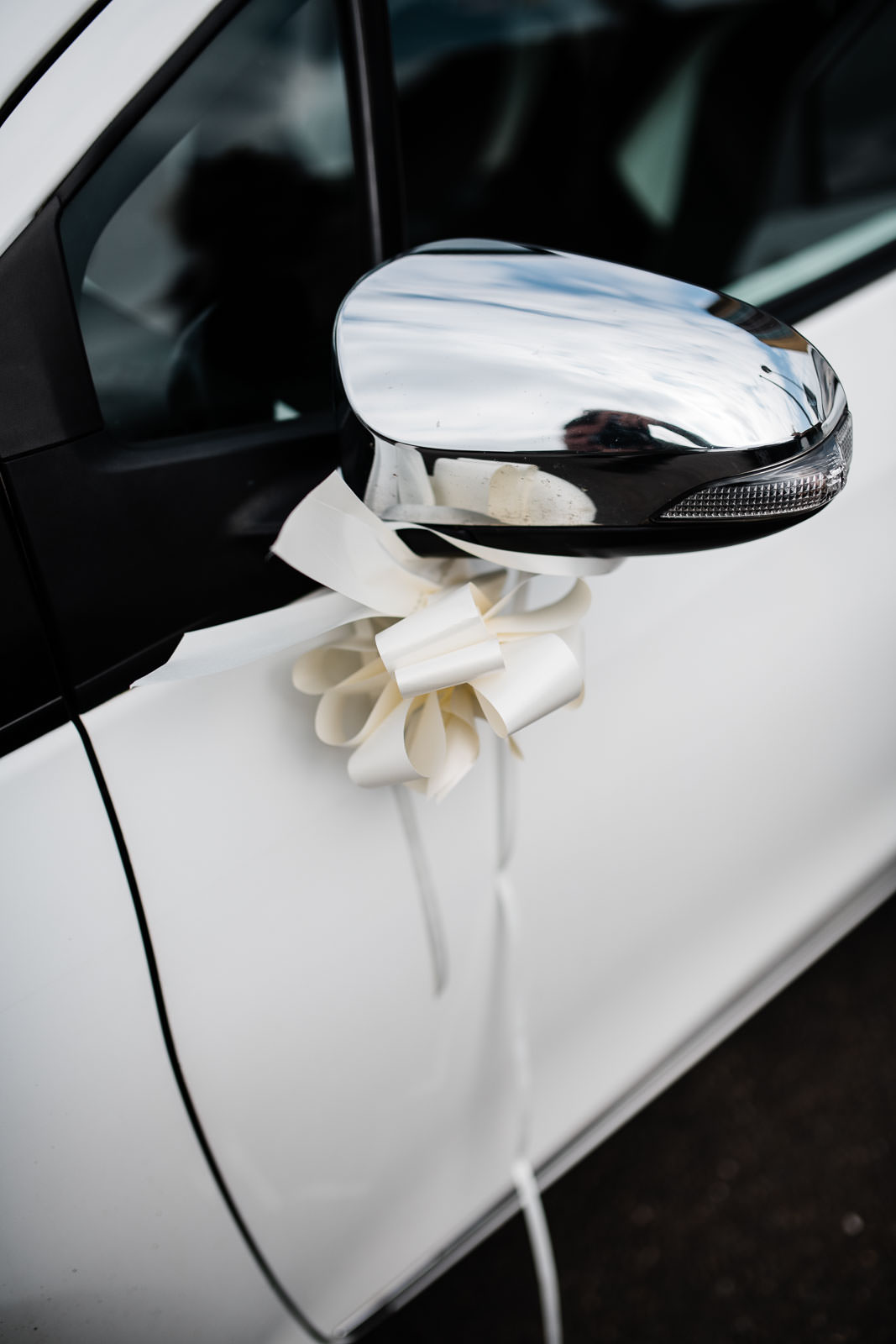 white curly ribbon on car wing mirror