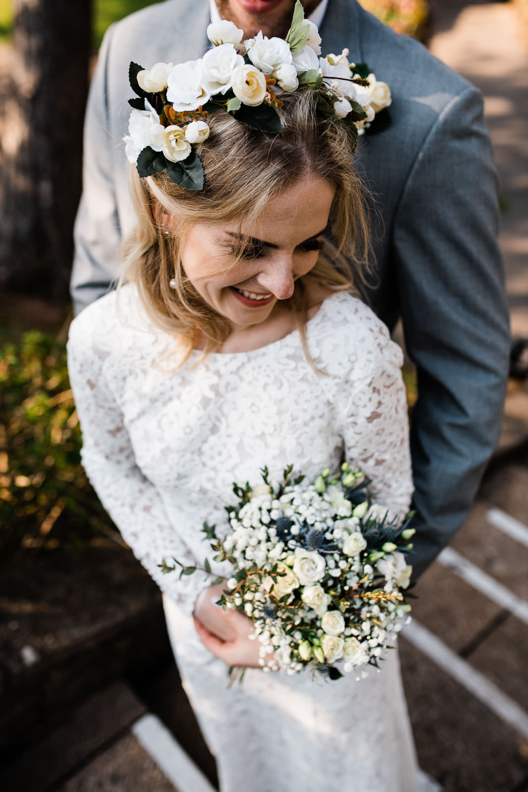 wedding bride in white dress holding green flowers