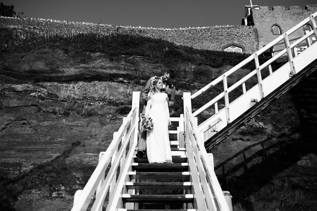 wedding bride walking down wooden steps in white dress