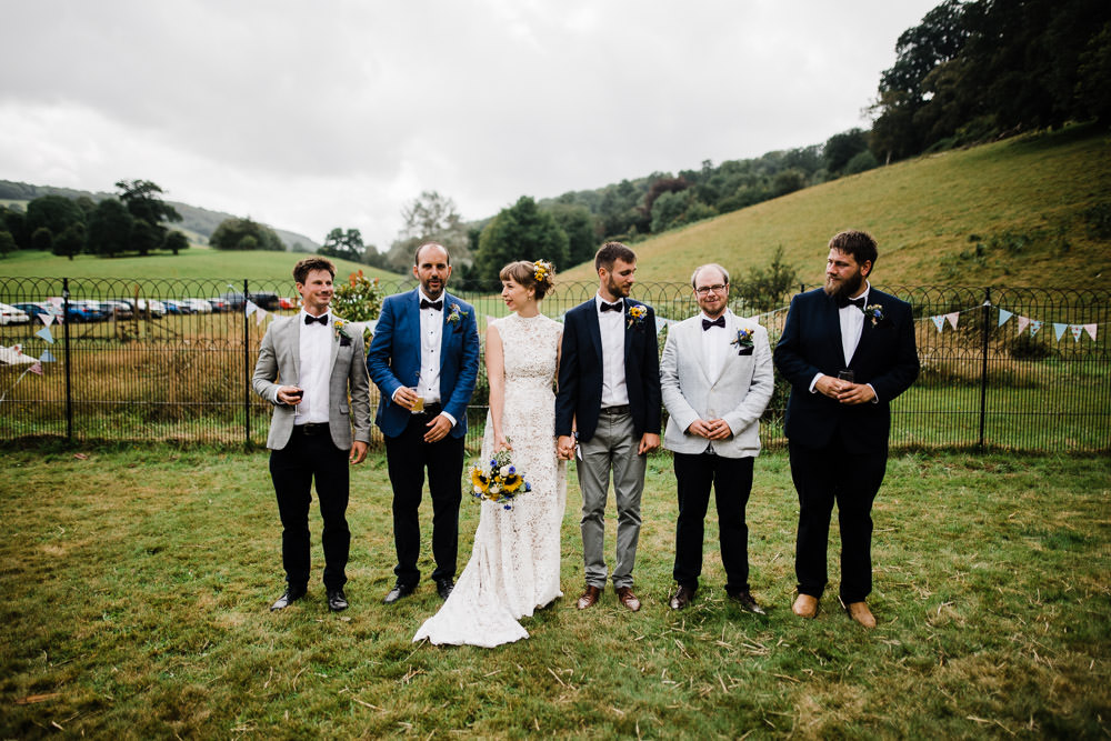bride and groom with friends on lawn