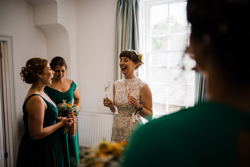 laughing bride holding champagne glass