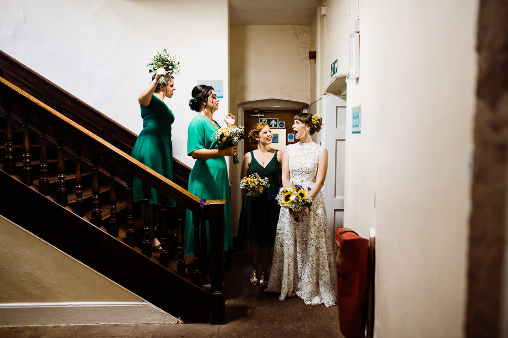 bridesmaids and bride stood in large stair well
