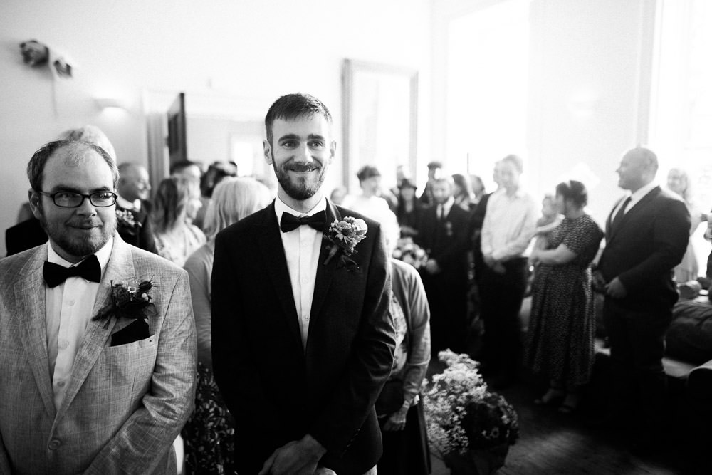 wedding groom smiling with best man