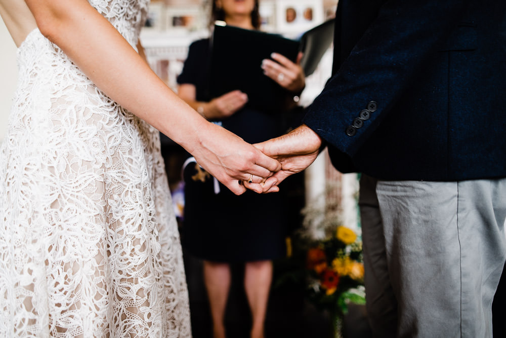 wedding couple holding hands at ceremony