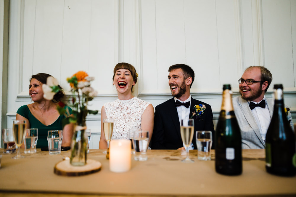 laughing bride sat at table with her friends