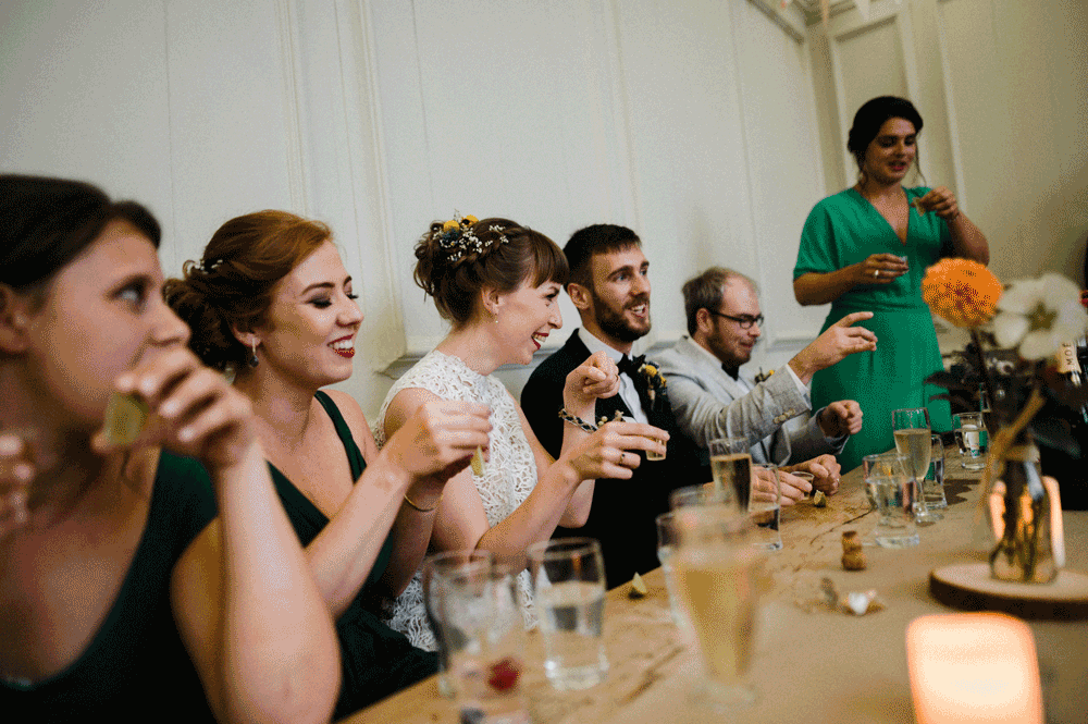 wedding party drinking tequila shots sat at table