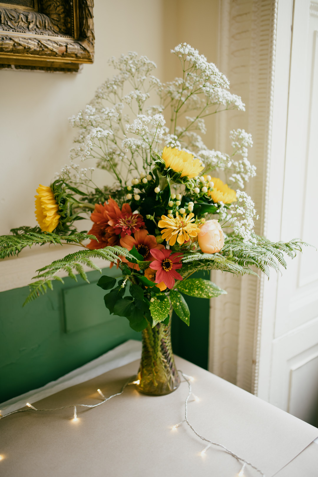 red and yellow wedding flowers in glass vase