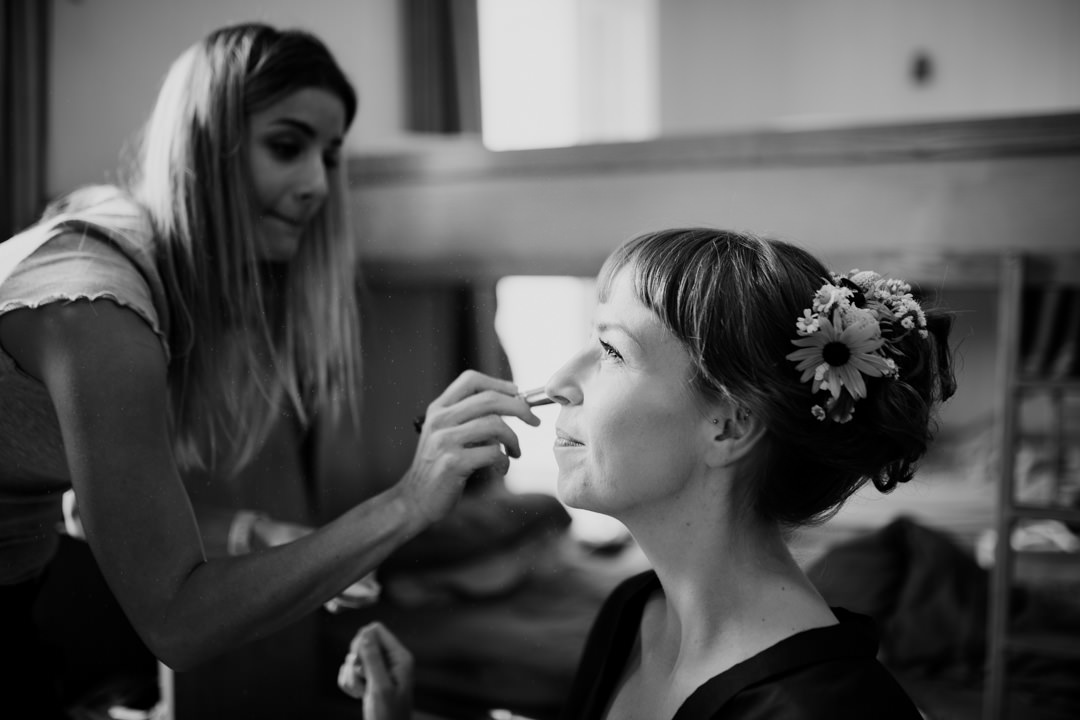 bride having make up applied sat in chair