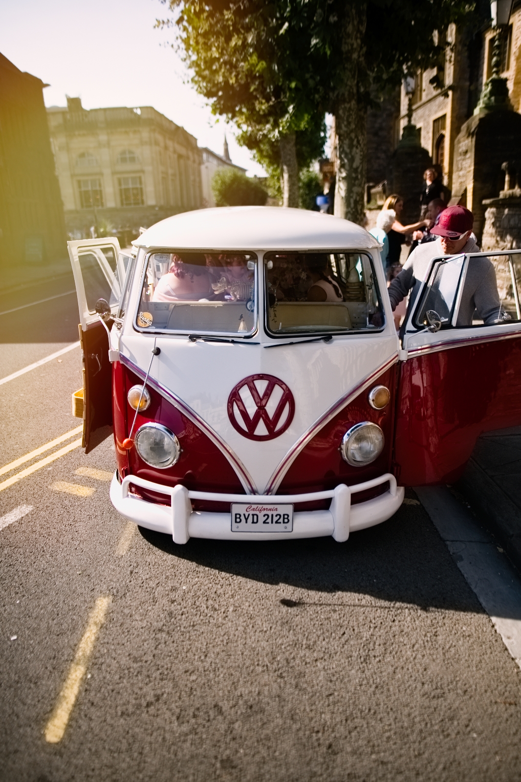 red Volkswagen camper van in urban town