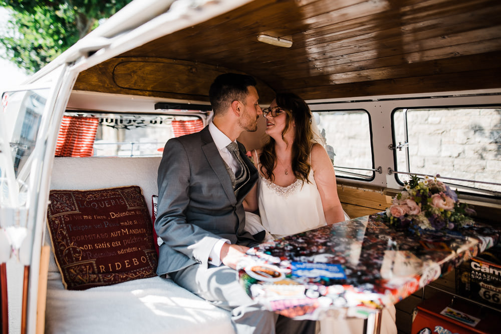 bride and groom kissing in vw camper van