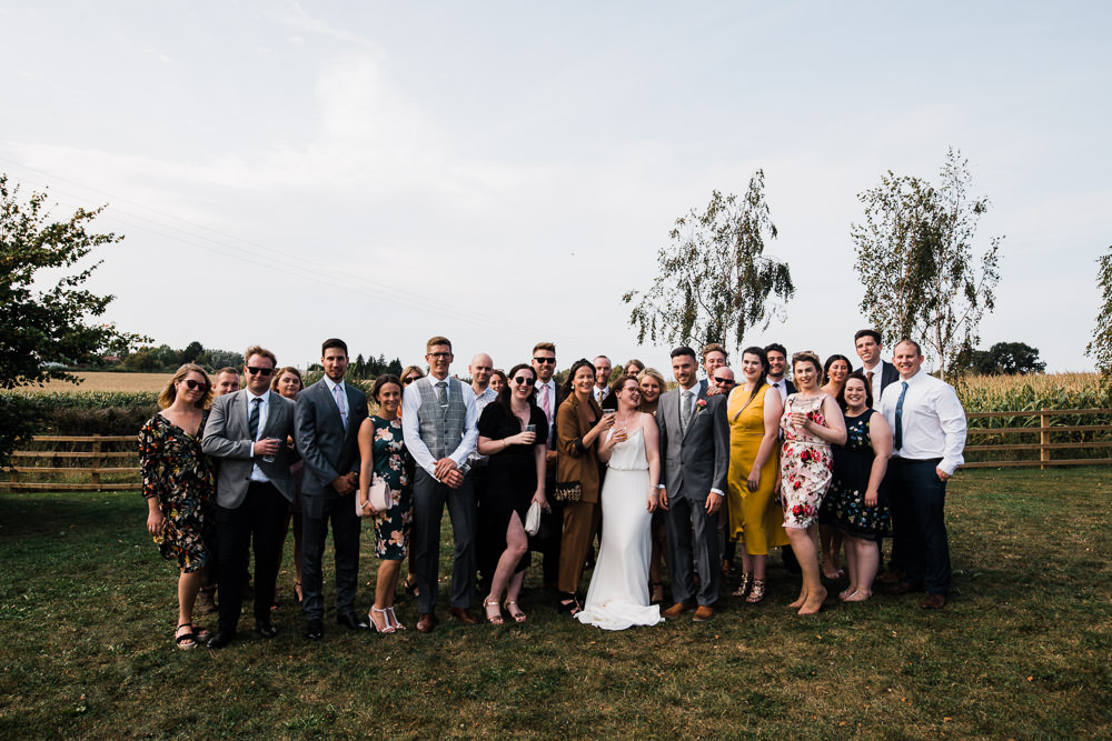 wedding party stood on grass