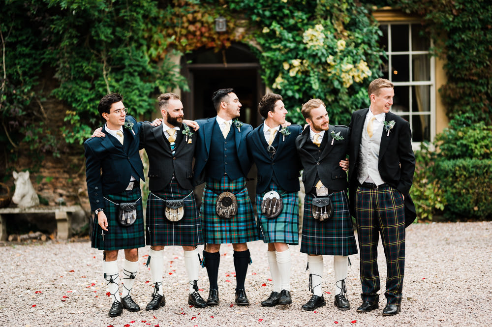 groomsmen stood laughing in a line
