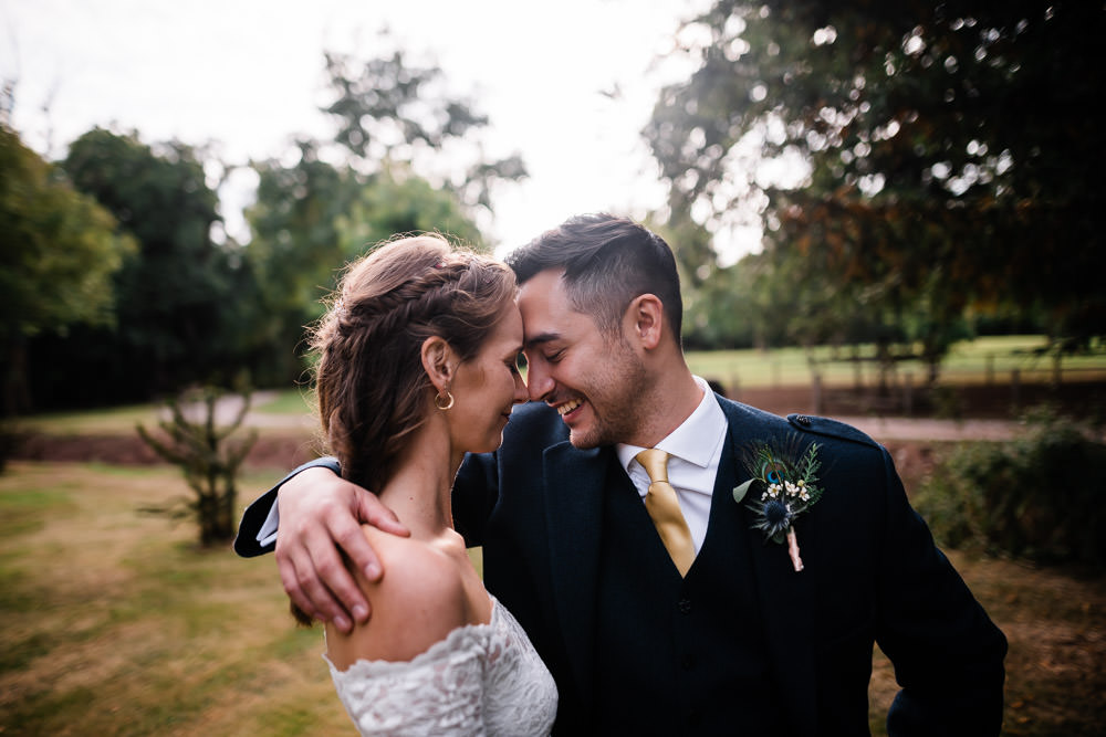 man and woman smiling laughing at wedding