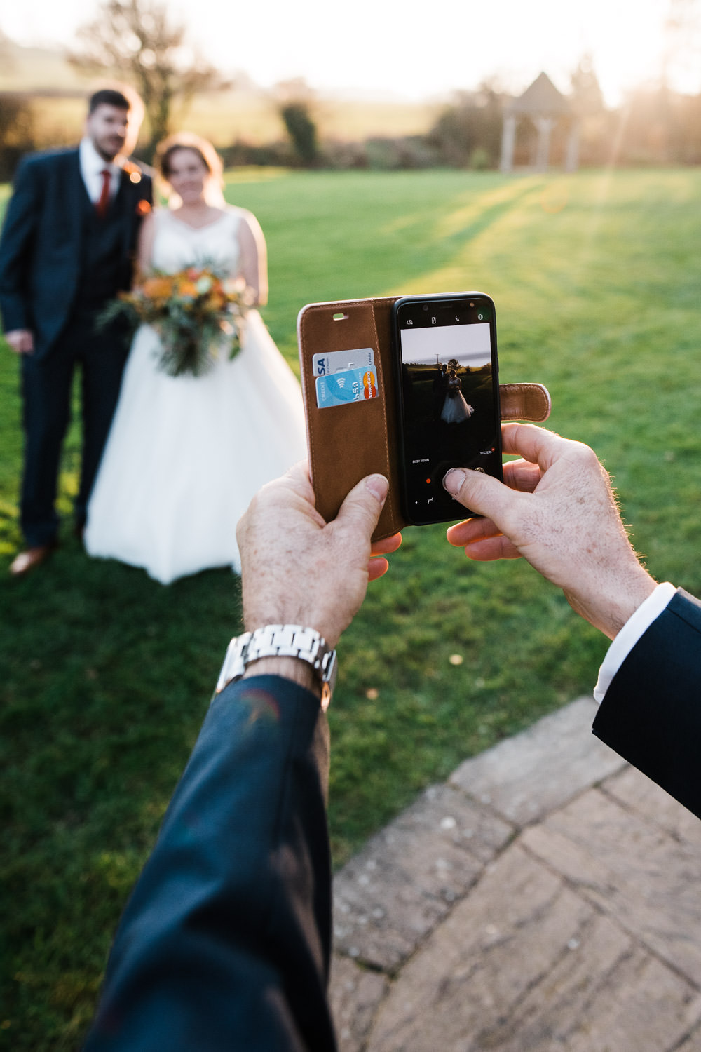 guest taking a photo at a wedding with iPhone