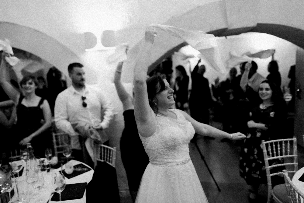 bride waving a cloth around at a party