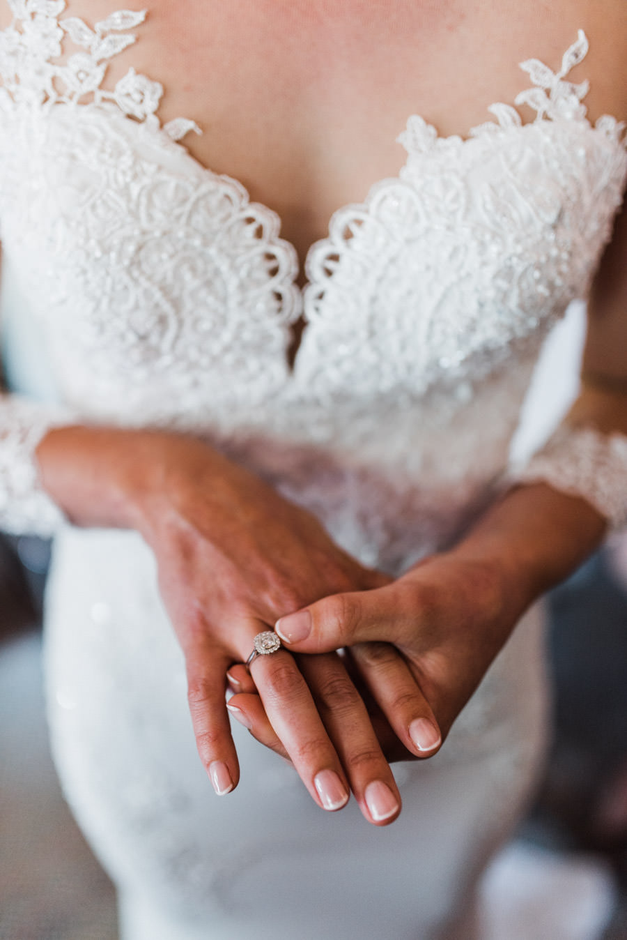 bride with engagement ring in white dress