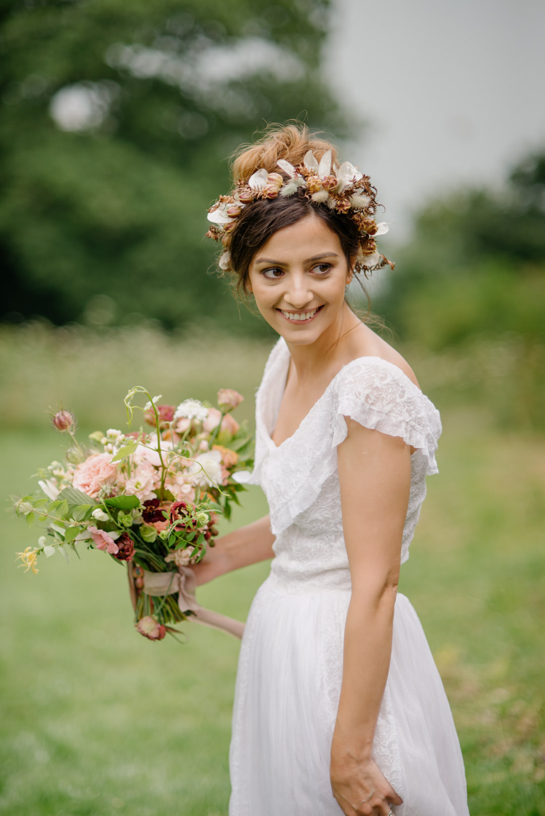 wedding bride waring flower crown stood on grass