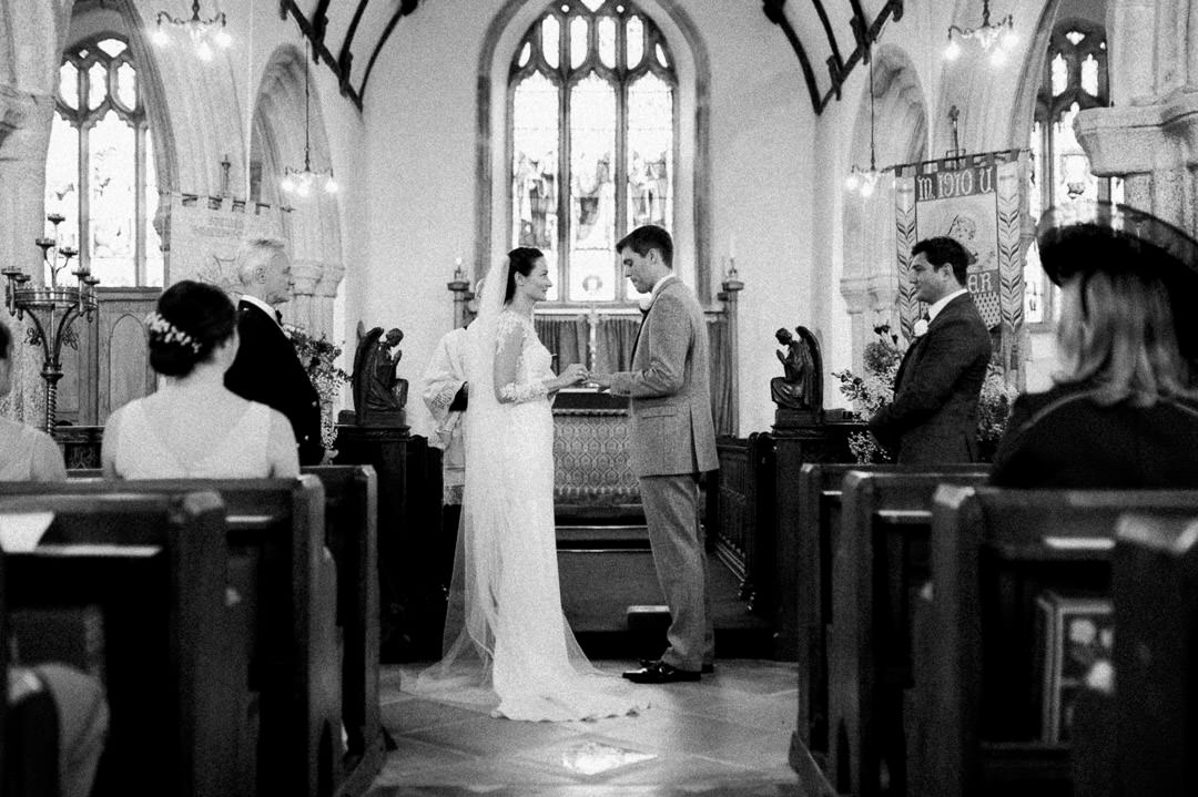 bride and groom standing at church alter