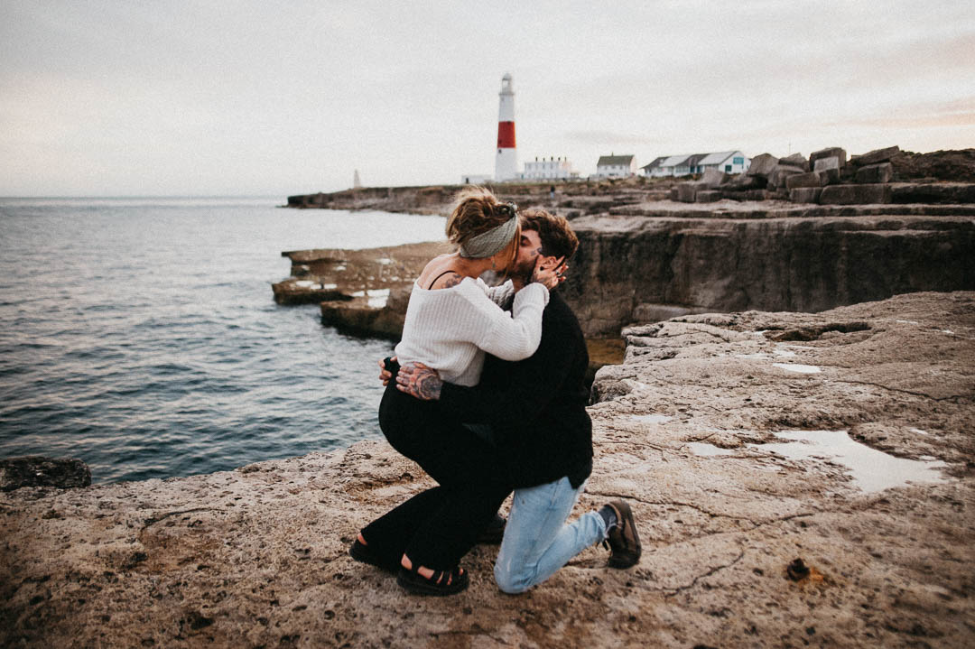 wedding proposal on beach near lighthouse