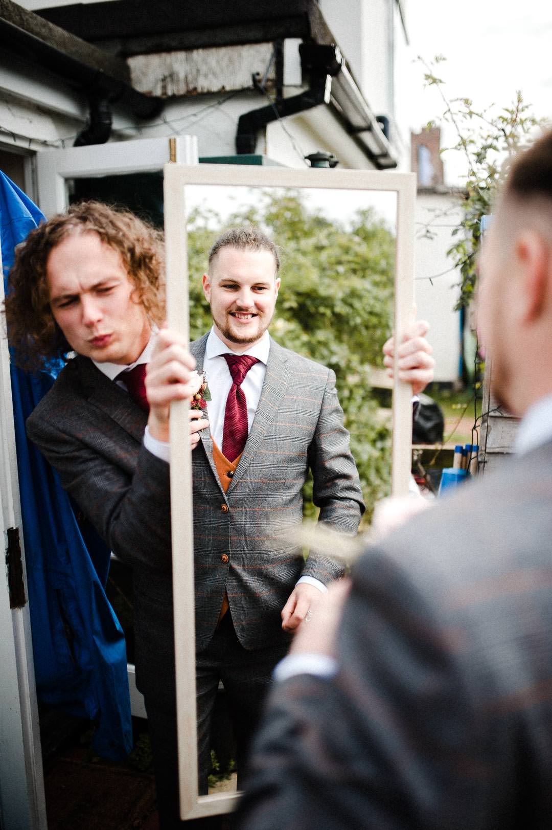 wedding groom looking in mirror