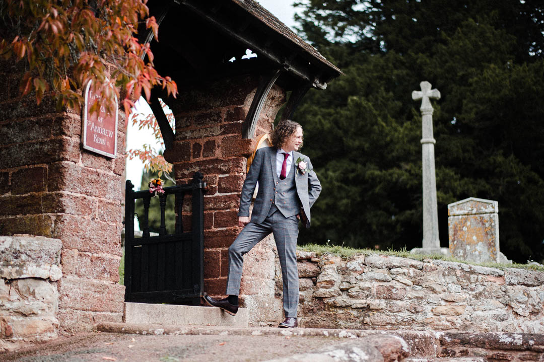man in suit outside church at wedding