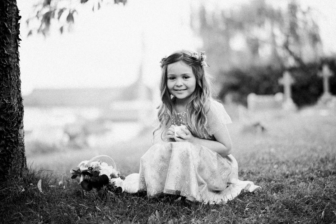 young girl in white dress with flowers in hair