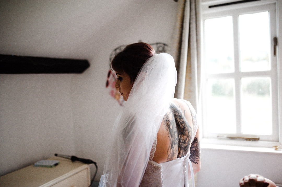 bride in white wedding dress in bedroom
