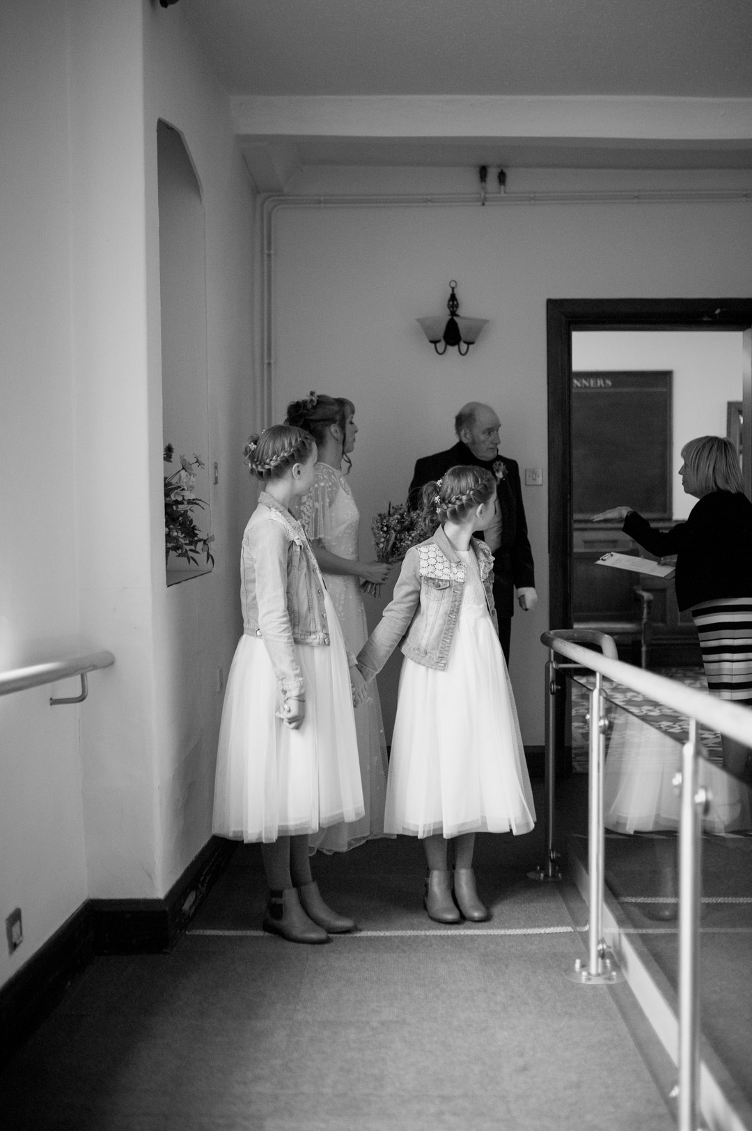 bridesmaids stood in church door holding flowers