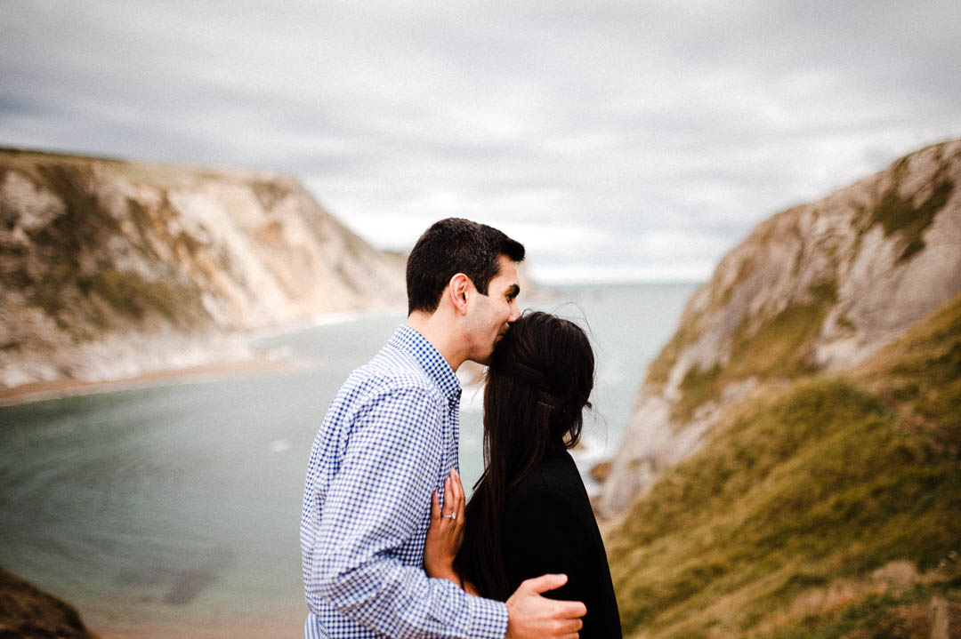 young couple kissing on coastline