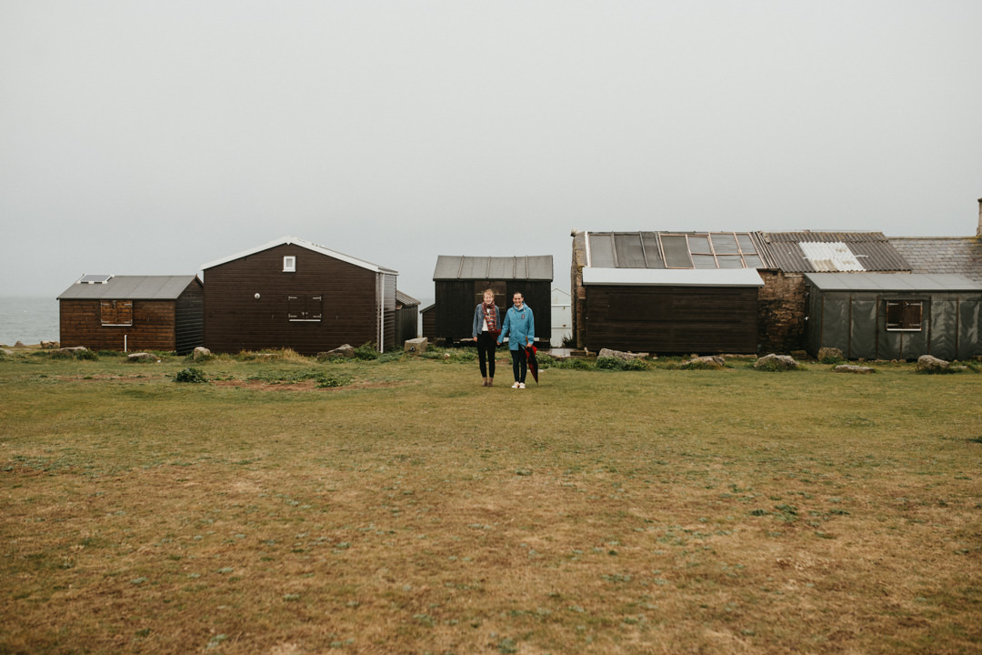 man and woman stood near beach huts Portland