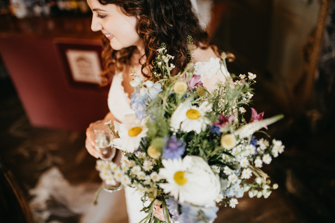 wedding bride holding flowers and champagne