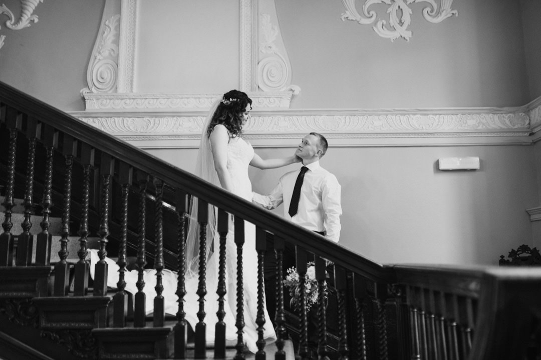bride and groom stood on large wooden stairs