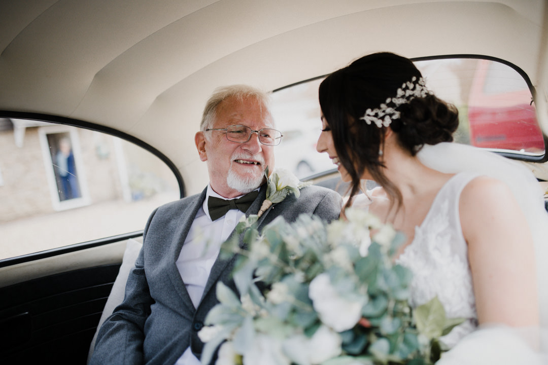 bride in car with father on back seats