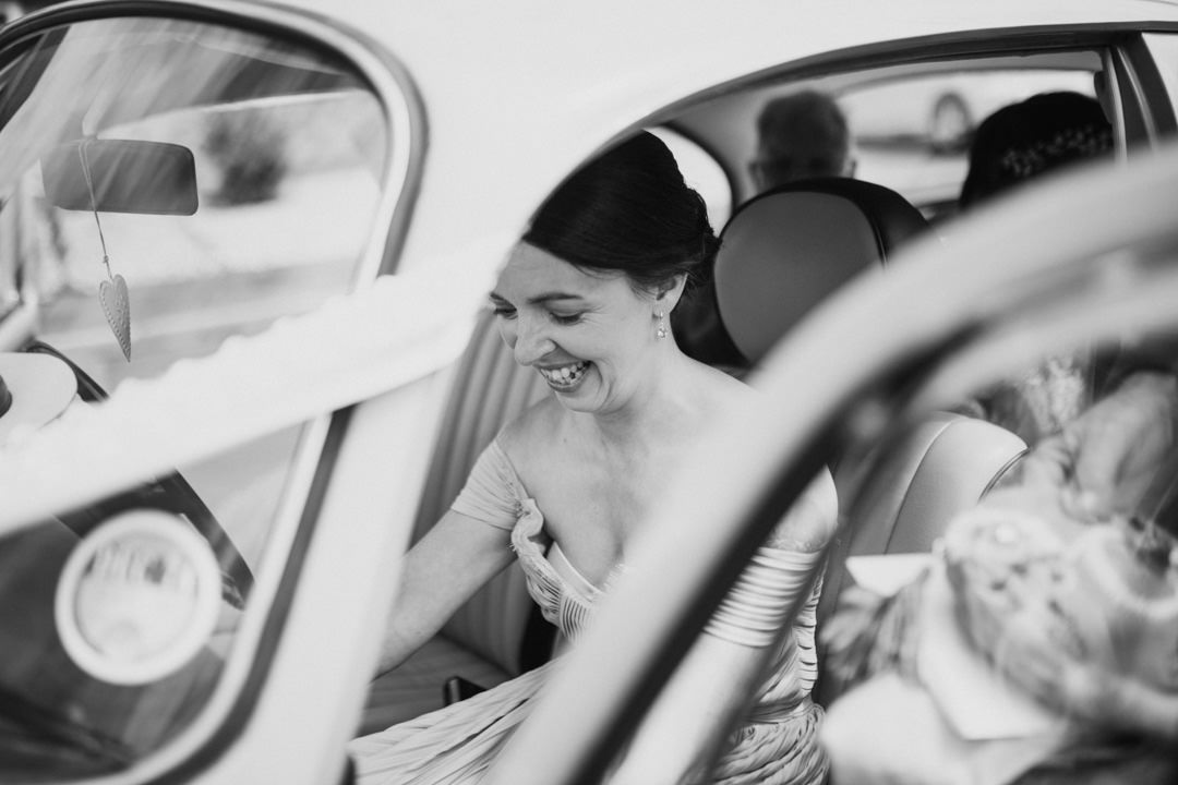 bridesmaid in classic car smiling