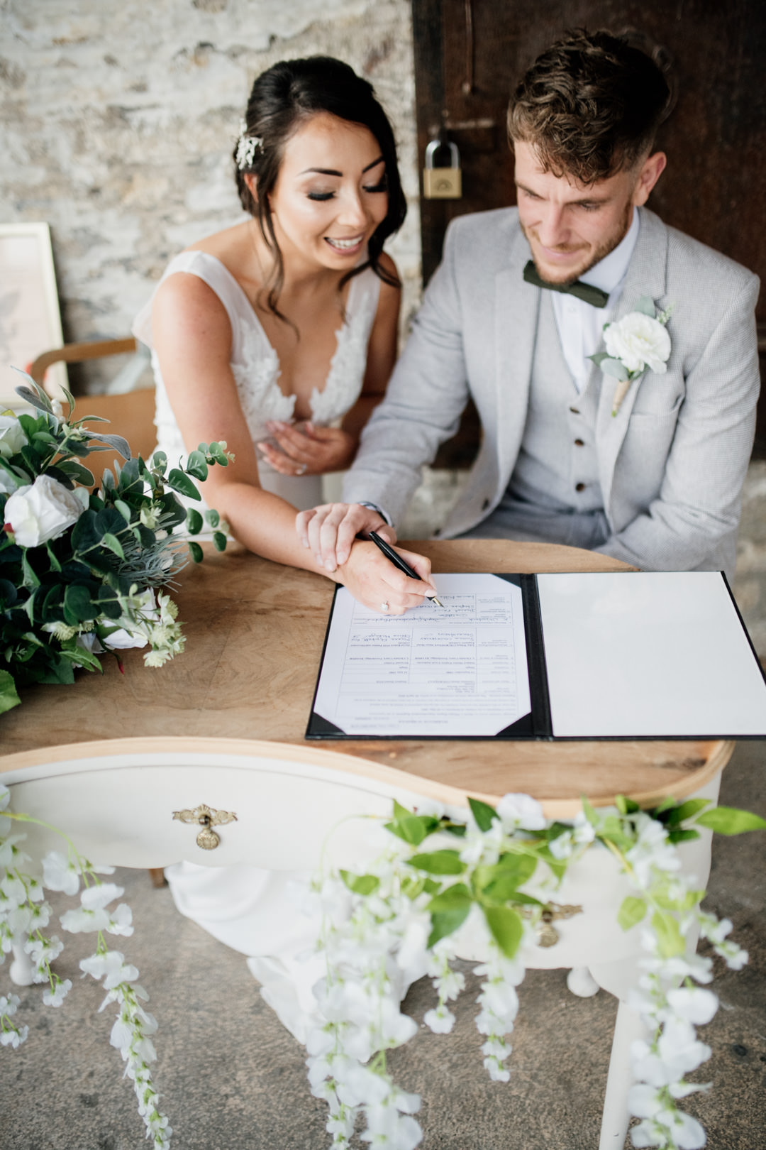 bride and groom signing wedding register