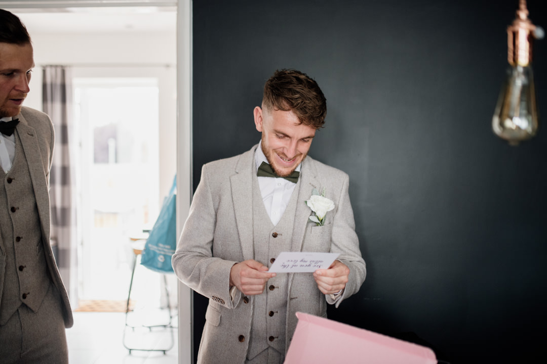 wedding groom reading letter and smiling