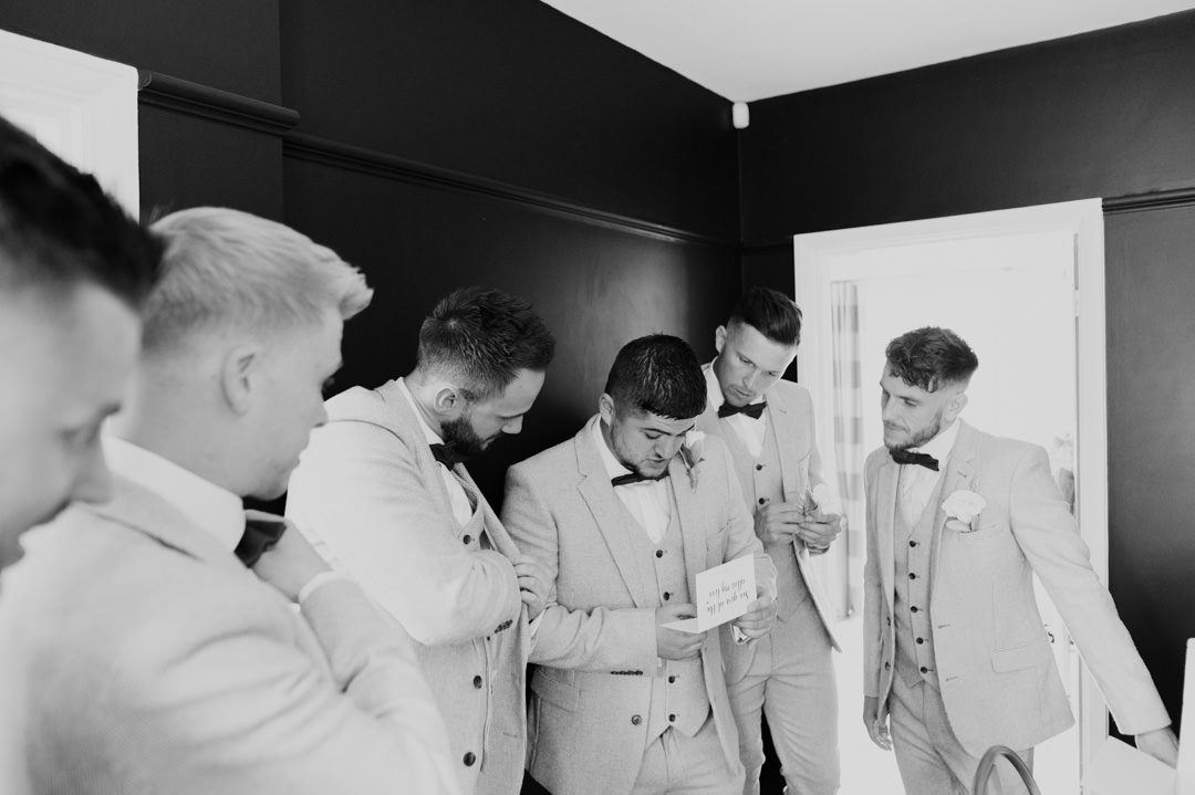 groomsmen in grey suit stood in a line
