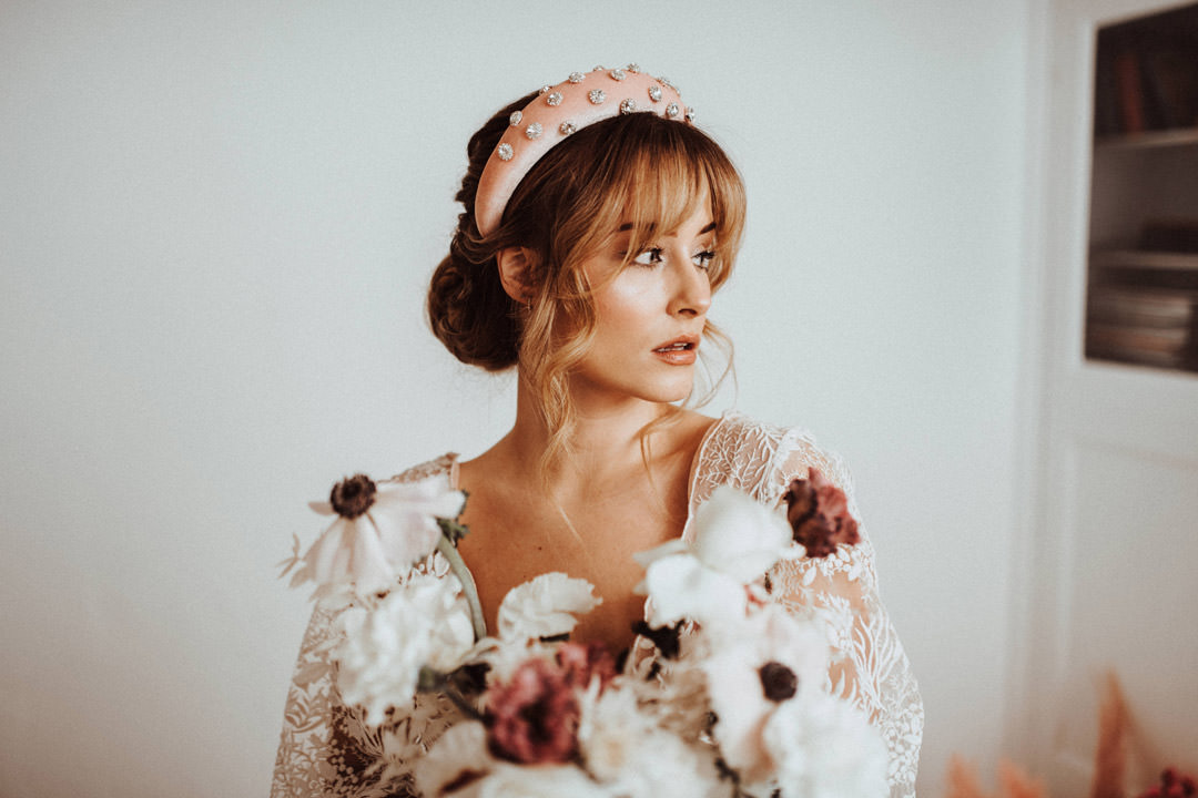 bride holding red and white flowers