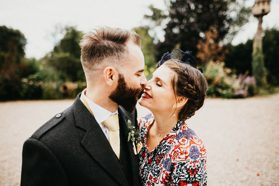 man and woman kissing at wedding