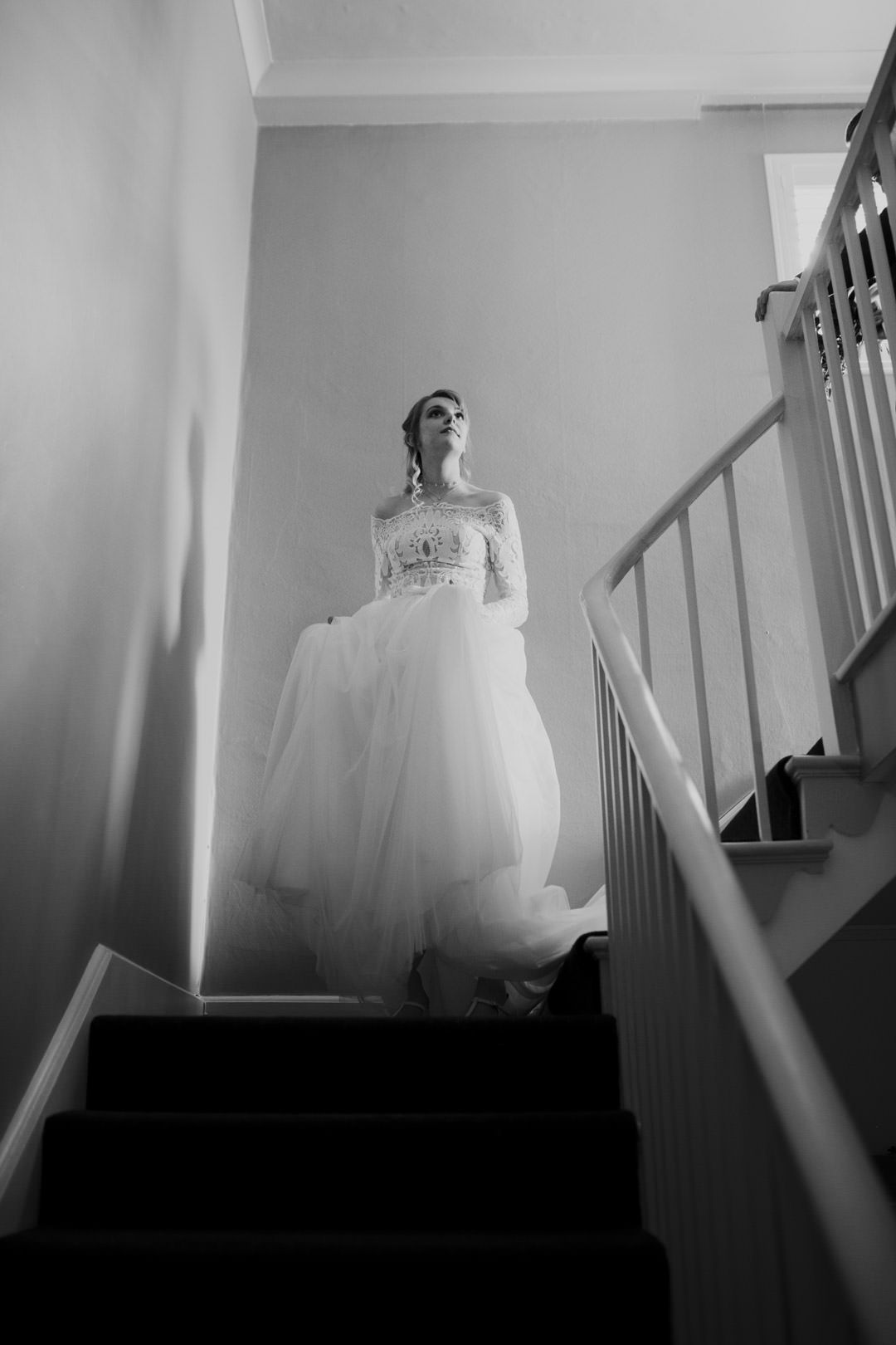 wedding bride walking down stairs in white dress