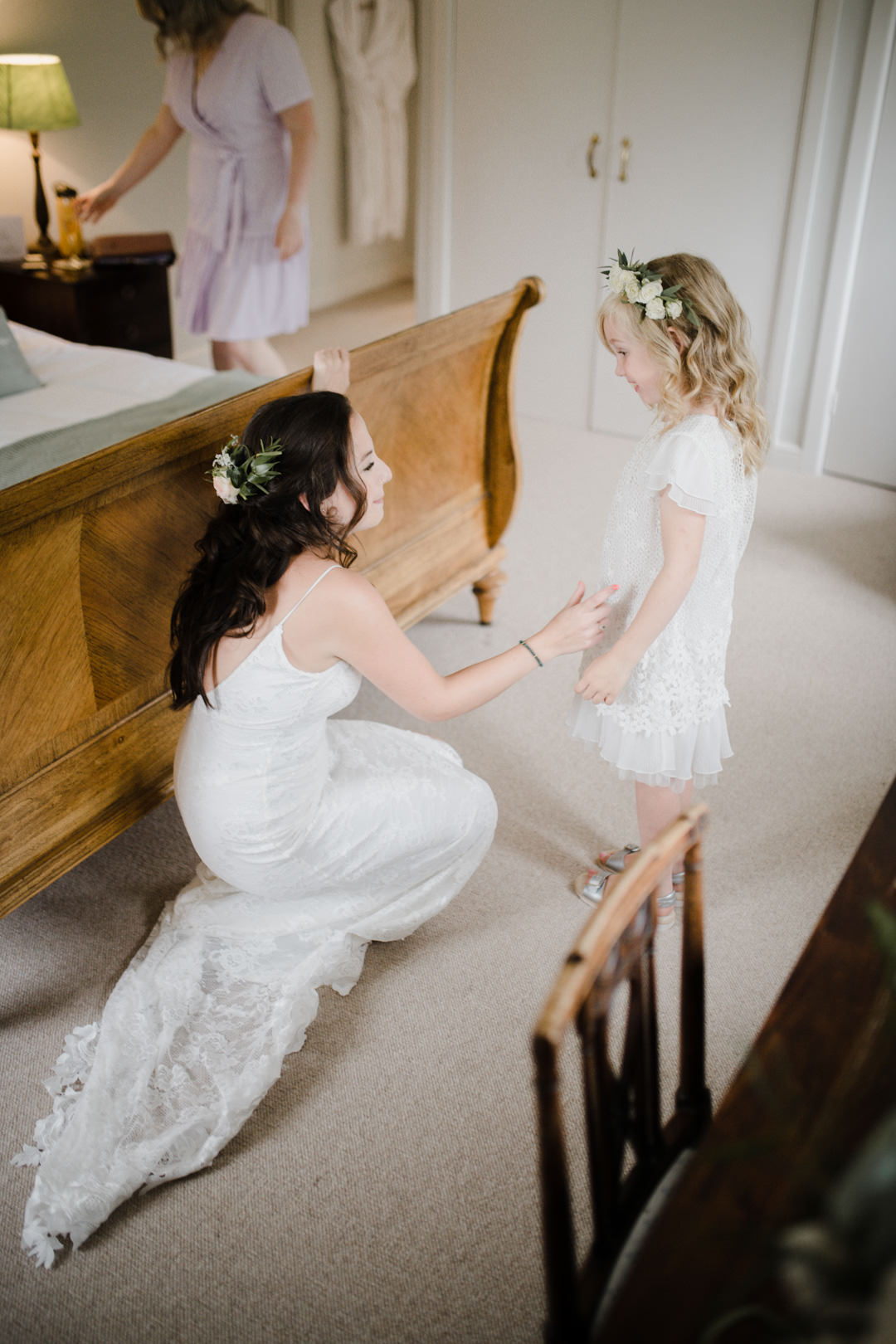 bride and little girl in bedroom smiling