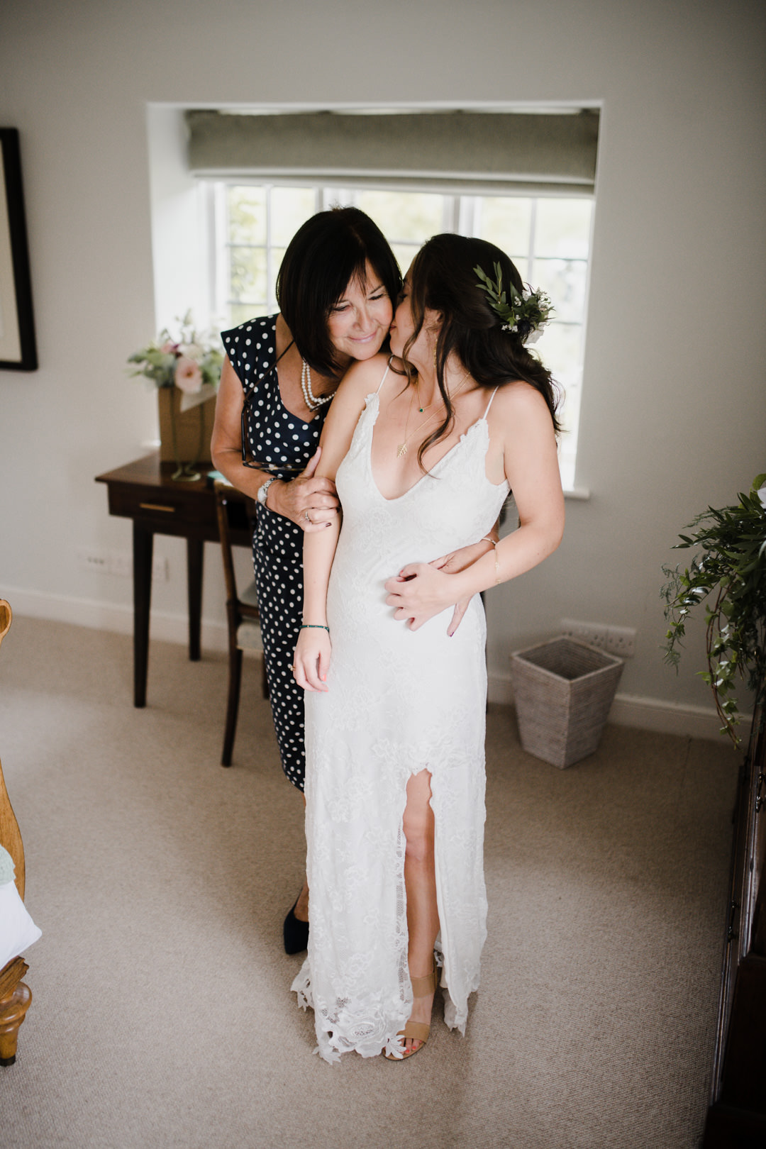 bride and her mother embracing in bedroom