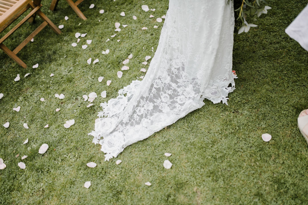 wedding dress and flower petals on grass
