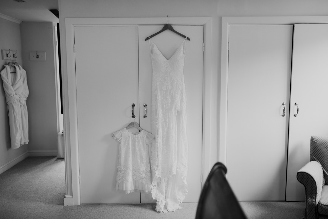 white wedding dress hanging on wardrobe door