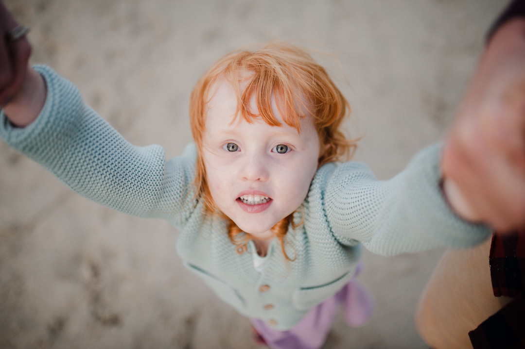 young girl with red hair on beach