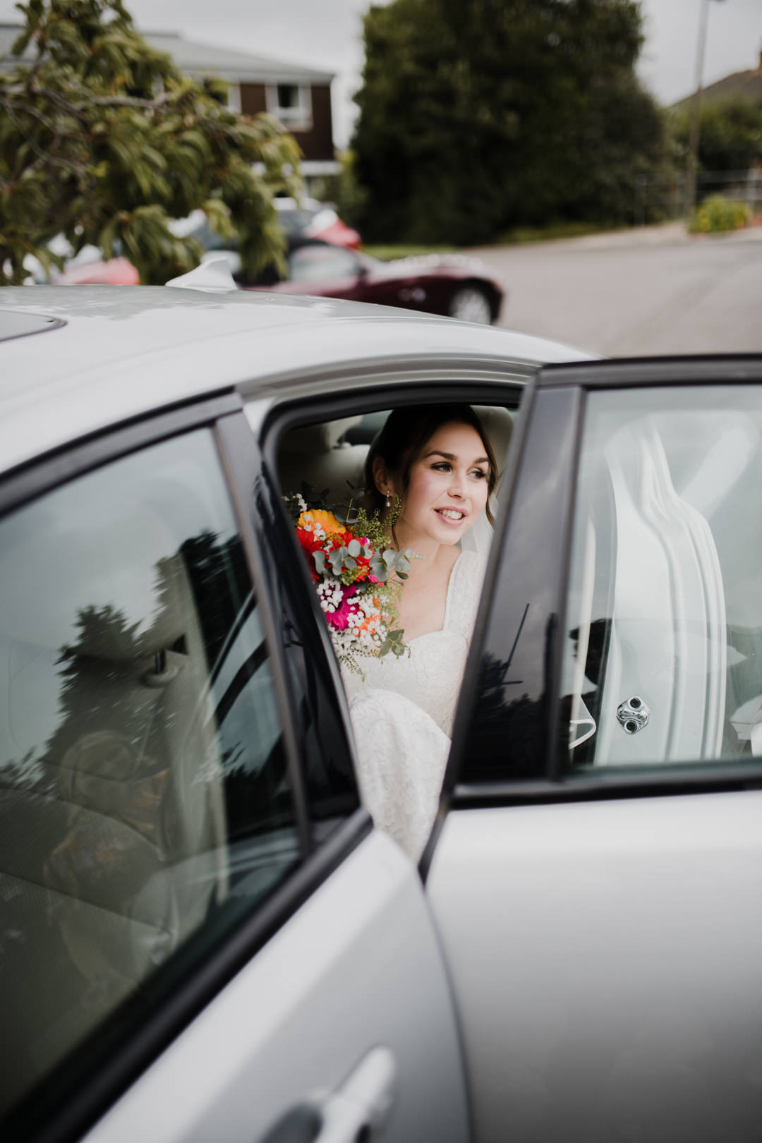 bride getting out of silver car