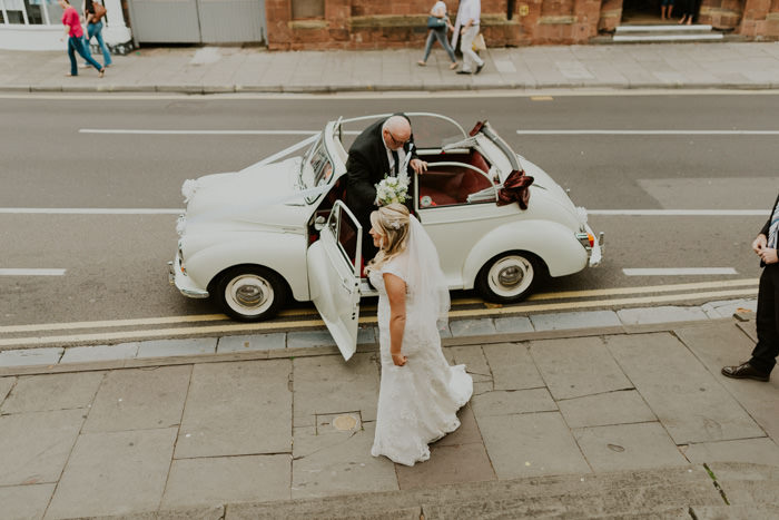 bride getting out of car outside church during day time
