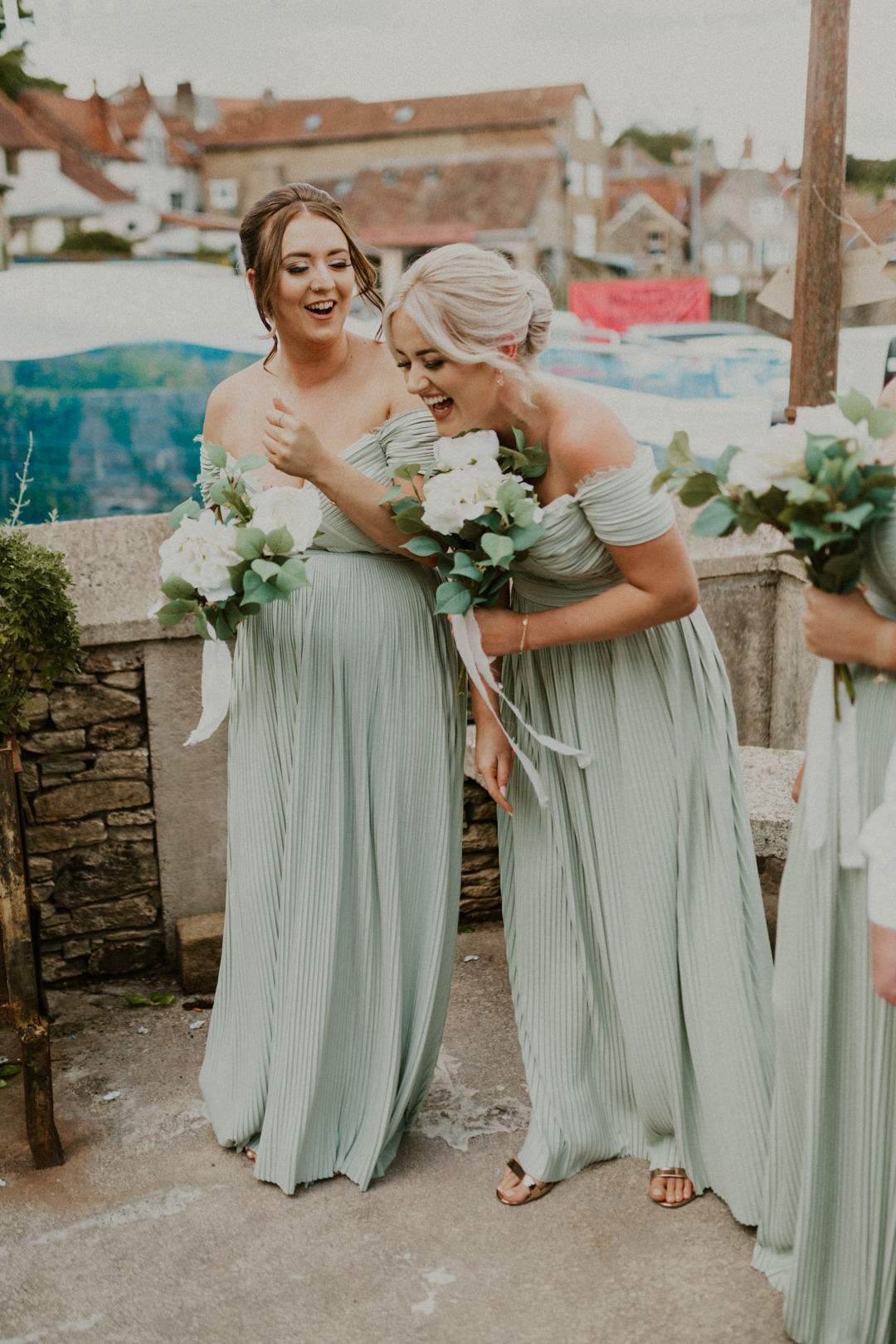 bridesmaids holding white flowers smiling