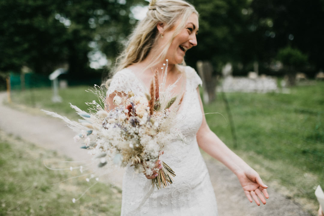 bride holding large flower bouquet