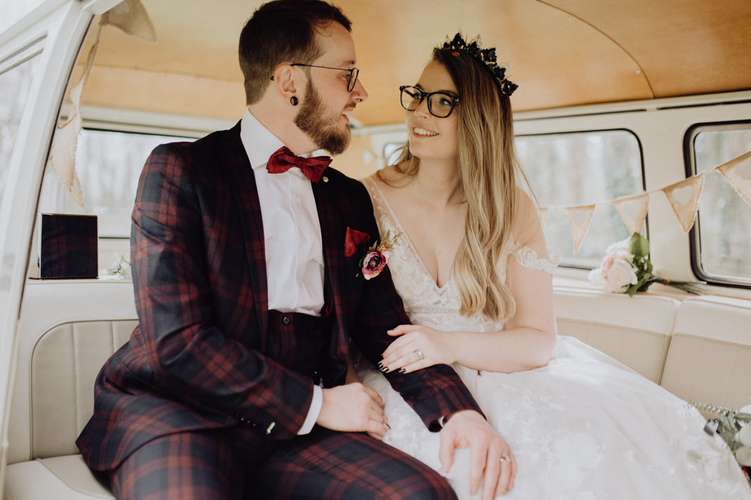 bride and groom sat in classic camper van